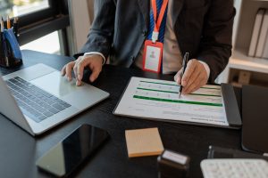 a businessman is reviewing accounting and financial statistics documents in his private office - T&A Solicitors