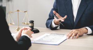 Lawyer advising a client during a regulatory investigation meeting